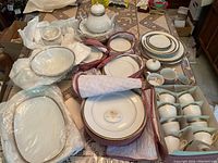 Overall arrangement of plates, bowls, teapot, cups in storage box