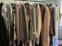 Full rack view of ladies size 10-12 clothing on a metal rod