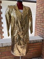 Front view of metallic gold brocade blazer on mannequin