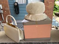 Hat and handbag displayed together on a box