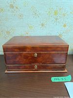 Closed view of the larger leather jewellery box showing polished brown leather and keyhole