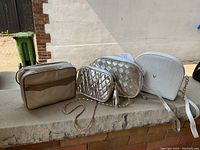 Front view of four purses side by side, showing colors and shapes