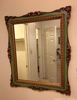 Front view of entire mirror mounted on wall showing frame color and design