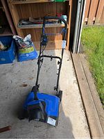 Front view of blue Kubalt snow thrower showing handle, motor housing and front chute.