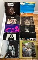 10 vinyl LP records arranged on floor showing covers