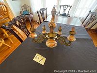 Overview photo of the orange and white porcelain chandelier showing four arms and detailed porcelain body.