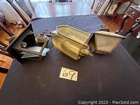 Three outdoor lamps on a table showing different styles and materials