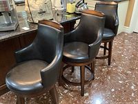 Three stools side by side at kitchen counter