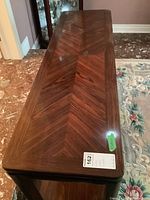 Front and top view of rectangular hall table showing rosewood veneer top with chevron pattern and black frame