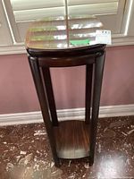 Full front view of the Lane plant stand showing the tall rectangular shape with rosewood veneer top and base sitting on dark wood legs.