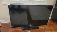 Front view of 58-inch Samsung TV on its stand