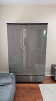 Front view of laminate wardrobe showing two doors and two lower drawers with glossy grey finish.