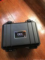 Pelican case with Aputure DEC branding, showing a compact, sturdy black case with secure latches.