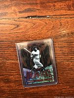 Front of Babe Ruth card showing player swinging bat with graphics and holographic foil