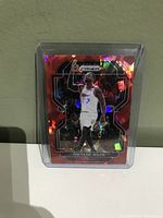 Front view of Dwyane Wade basketball card with holographic Prizm red design, showing player in Miami Heat uniform.