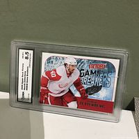 Front view of the graded 2009 Upper Deck Victory Henrik Zetterberg hockey card, showing the player in action in Detroit Red Wings uniform, with GMA grade 8.5