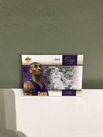 Front of Kobe Bryant basketball trading card showing color image of Bryant in Lakers jersey and black-and-white action image, with Lakers branding and card number.