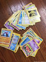 Spread of various Pokémon cards showing fronts with characters like Blastoise, Rattata and an energy card