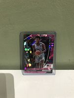 Holographic basketball trading card featuring James Wiseman, encased in plastic protector.