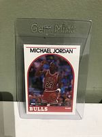 Front side of Michael Jordan basketball card showing action shot and team details encapsulated in a Gem Mint protective sleeve.