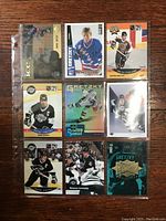 Photo showing nine Wayne Gretzky hockey cards in protective pages, front side with various designs and finishes.