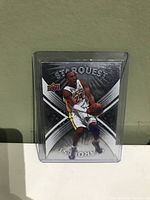 Front of Kobe Bryant StarQuest basketball card showing player in Lakers uniform in action pose, card in protective case.