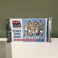 Front of the sealed pack showing the USA Basketball logo, label 'The Greatest Team Ever Assembled,' and image of the 1992 Dream Team players.