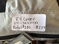 Close-up photo of the white label on the bag showing RV cover dimensions and price.
