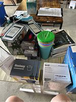 Overview of the lot showing various boxed items including light bars, air mattress pump, and solar lights.
