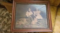 Full view of the antique framed photograph showing the children and dog
