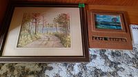 Overview of both framed items together on carpet background