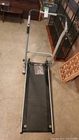 Front view showing treadmill structure, black walking belt, and silver-gray frame