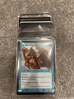 Photo of Magic: The Gathering cards showing Balshan Collaborator card on top with bird soldier creature artwork.