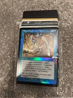 Image showing a close-up of a Magic: The Gathering card named Aura Graft, blue bordered, holographic foil.