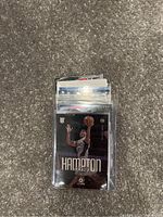 Stack of NBA basketball cards inside protective sleeves displayed top card featuring player Hampton