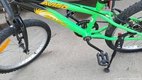 Close-up side view of green Avago bike frame and front wheel