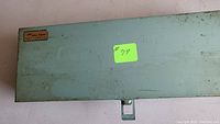 Closed light blue/green metal storage case with Wilton Tony Formosa label on top and a green sticker with #79.
