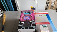 Thunder Ball plasma light box next to plastic bottle bank