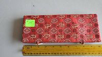 Red cloth-covered box with traditional oriental patterns, measuring about 9.25 inches long.