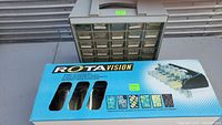 Overview of two storage units, one used assembled with drawers and one new in box branded ROTAVISION.