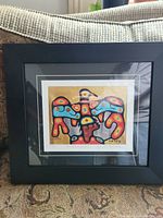 Front view of framed art print showing colorful Thunderbird headdress design and signature.