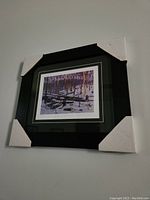 Framed and matted print titled 'Winter in the Woods' hung on wall with corner protectors.