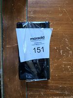 Partially wrapped Nintendo DS handheld device with MaxSold label attached obscuring some details.