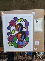 Print with bright, colorful stylized image of two children embracing, signed and numbered, taped to backing board along with certificate.