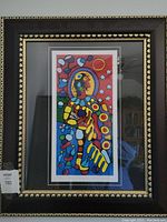 Front view of framed 'Shaman Astral Guide' print showing vibrant colors and decorative black and gold frame.