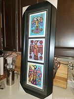 Full view of the framed triple Thunderbird prints showing the black frame and matting.