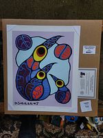 View of the full print showing the boxed packaging and details on the print including the signature and numbering