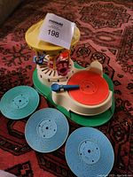 Full view of the Fisher Price vintage vinyl circus toy with three blue vinyl records laid out