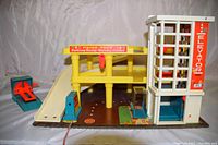 Front view showing yellow parking levels, elevator, ramps, and service center sign