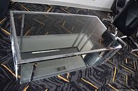 View of rectangular glass coffee table from above showing top glass surface and chrome frame